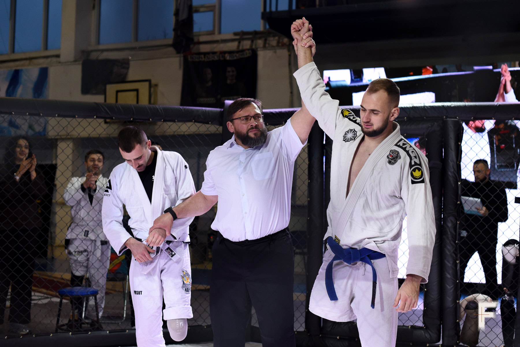 Арбітр піднімає руку ветерана-переможця під час змагання з джиу-джитсу серед поранених військових.