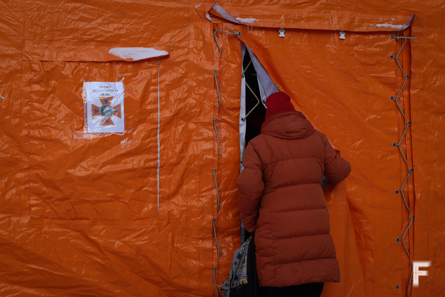 Людина заходить до пункту незламності на Троєщині під час блекауту в Києві.