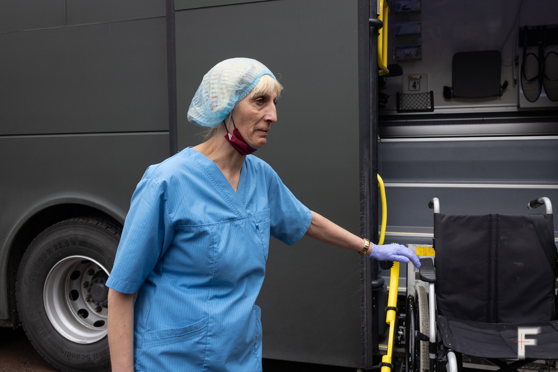 Людмила, медична працівниця, з сумом очікує звільнених полонених біля автобуса, Україна, 2026