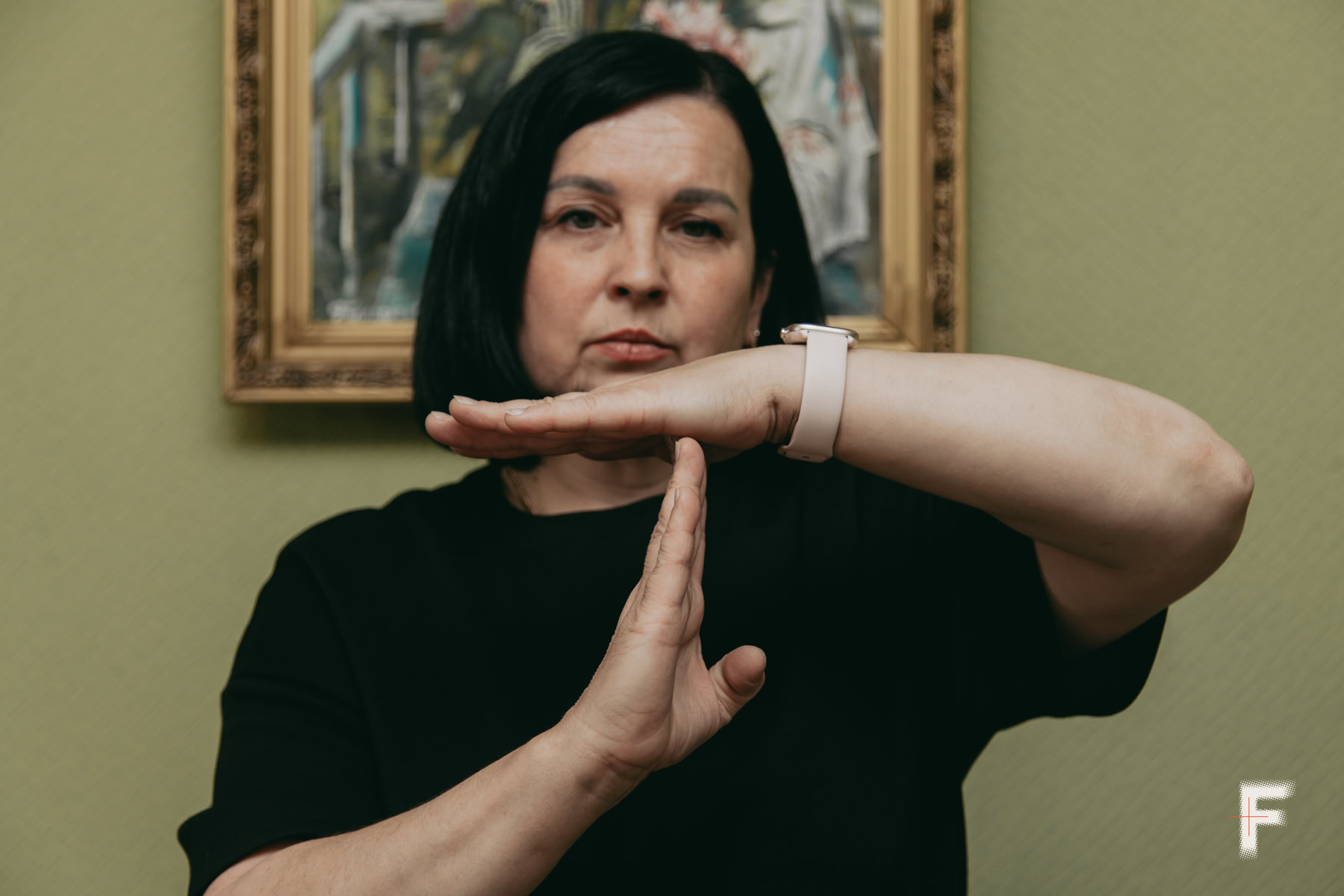 Ірина Лісова показує жестовою мовою фразу «Війна, зупинись» в офісі УТОГ.